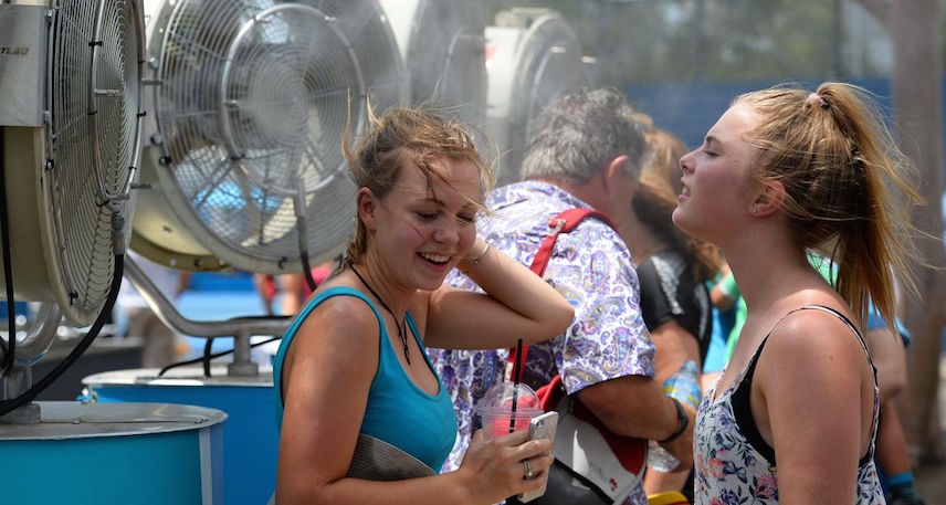 People cooling off near mist fans