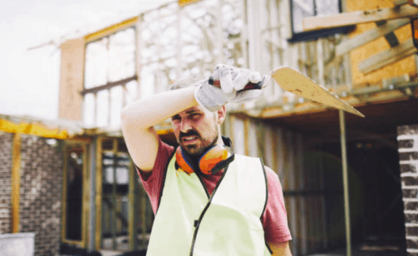 Man working in hot weather at a construction site.