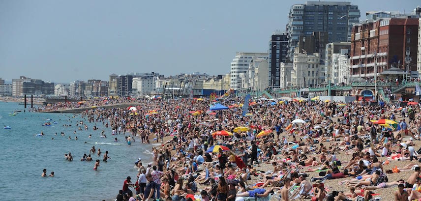 Crowded beach on hot summer day