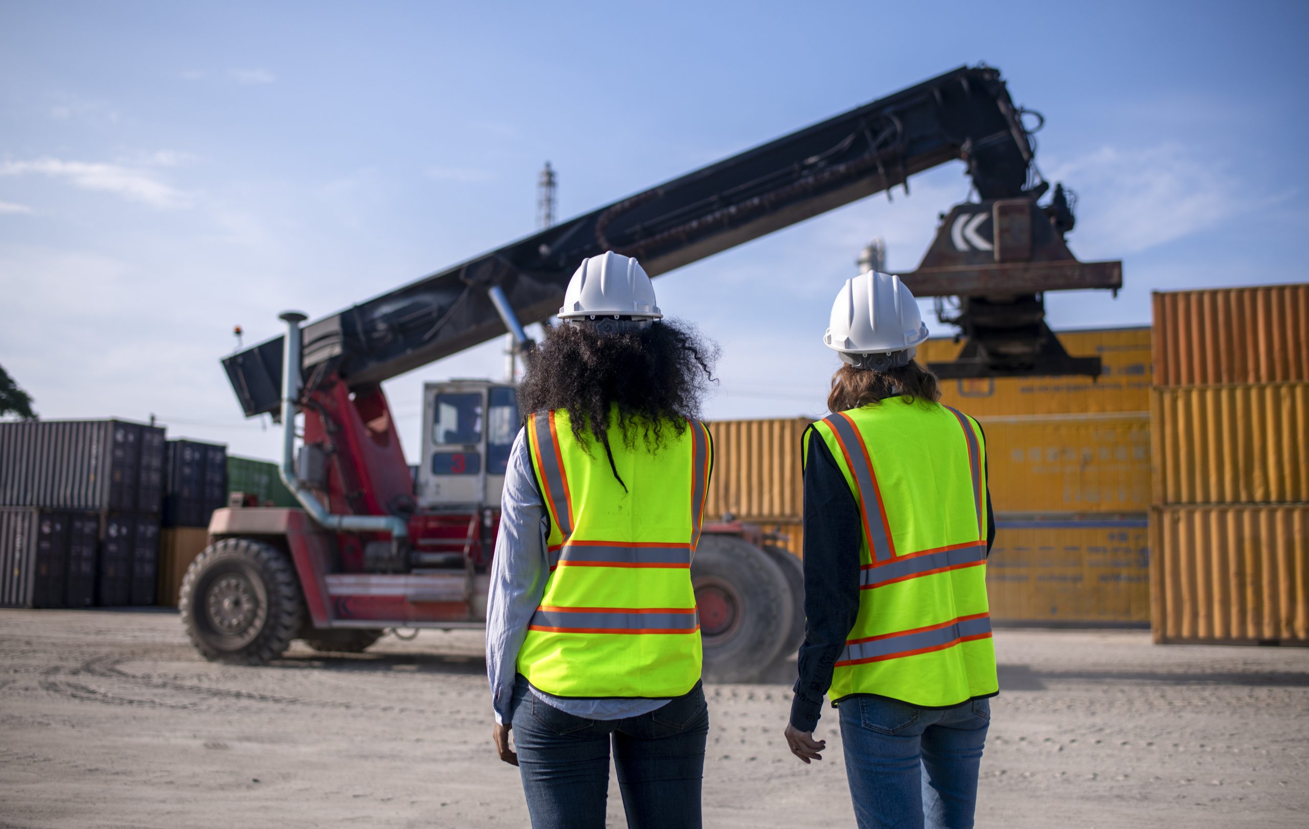 Dock Worker Inspecting Container Data on a Computer