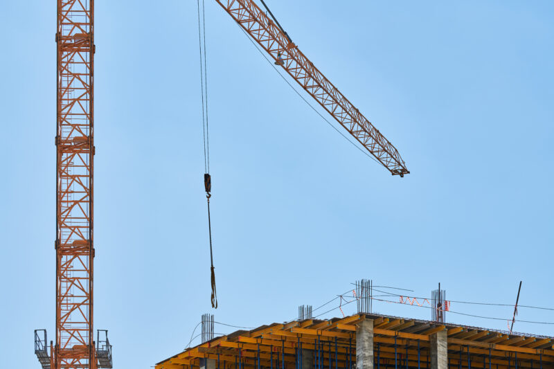 Construction-crane-working-on-a-building-complex