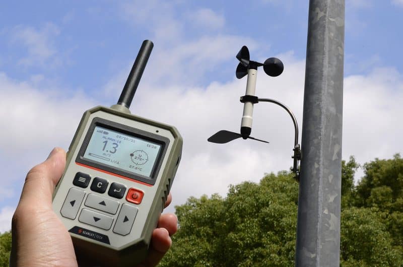 meteorologist-measuring-wind-using-anemometer-at-weather-station