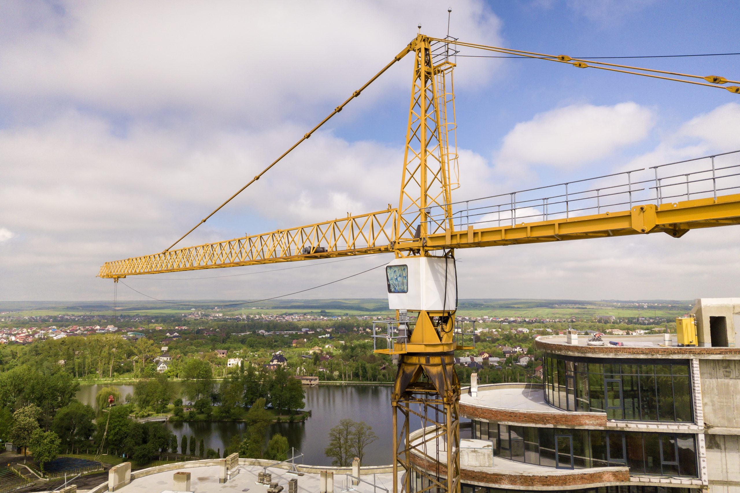 Yellow crane atop building under construction